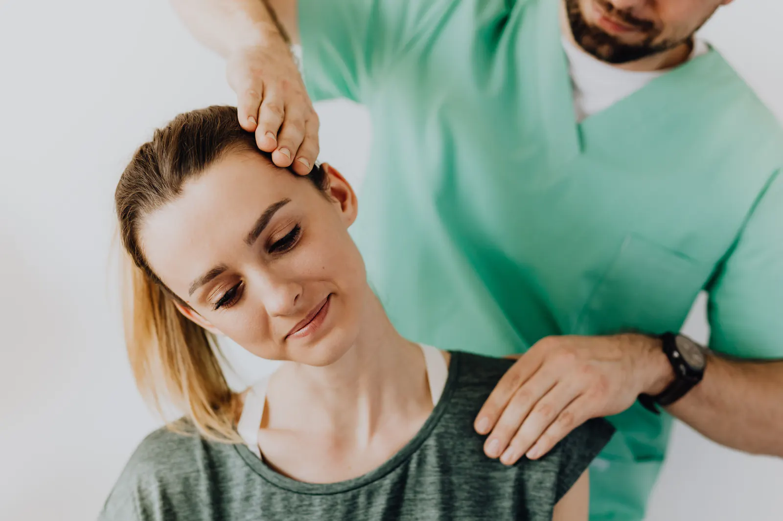 Chiropractor performing a neck and shoulder adjustment