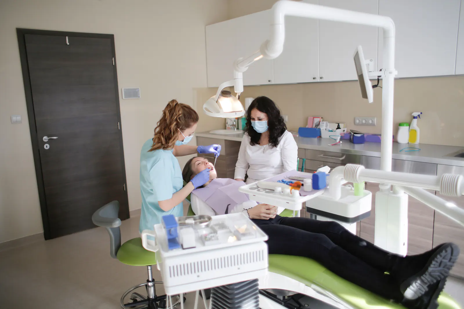 Dentist examining a patient in a dental treatment room