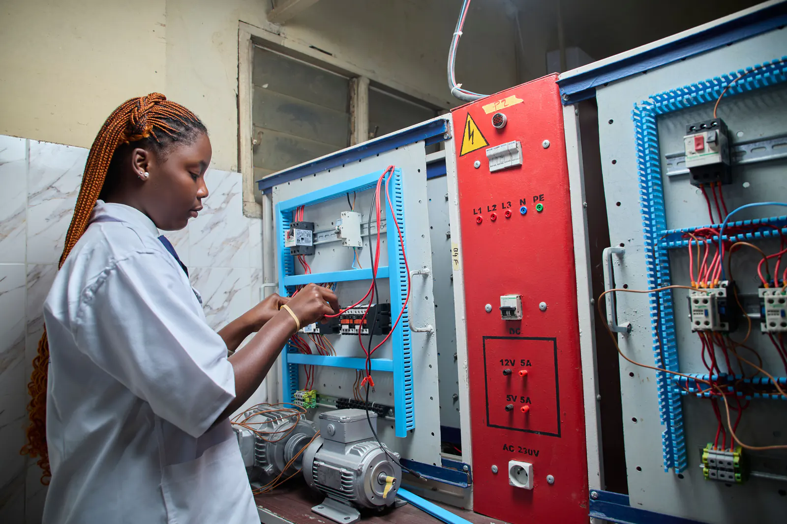Electrical contractor testing wiring in an electrical panel