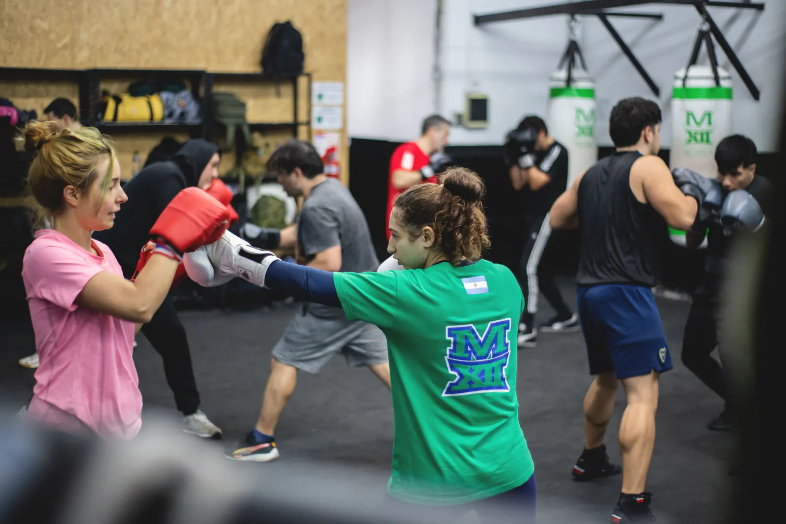 Members training with boxing gloves in a fitness studio