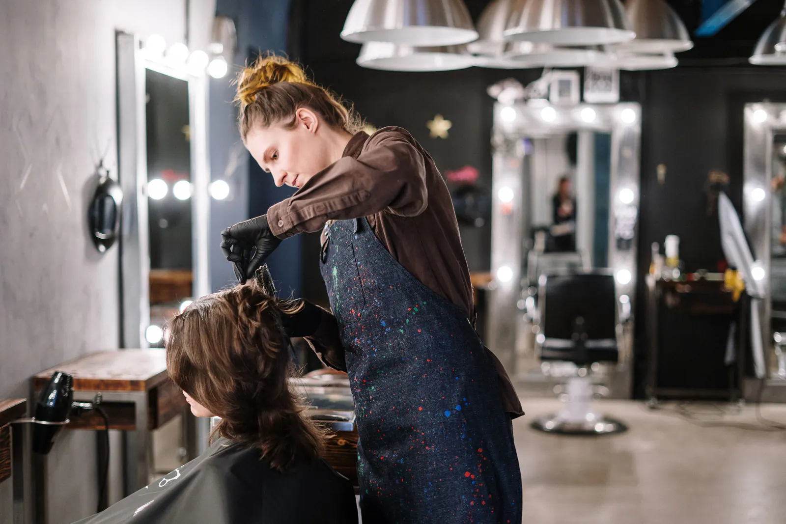 Hair stylist cutting hair for a client in a salon