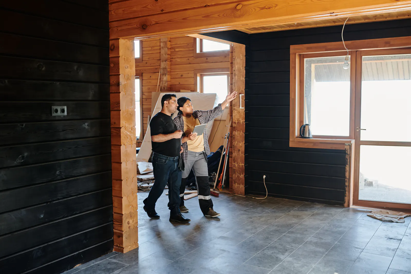 Remodeling contractors inspecting work inside a home renovation