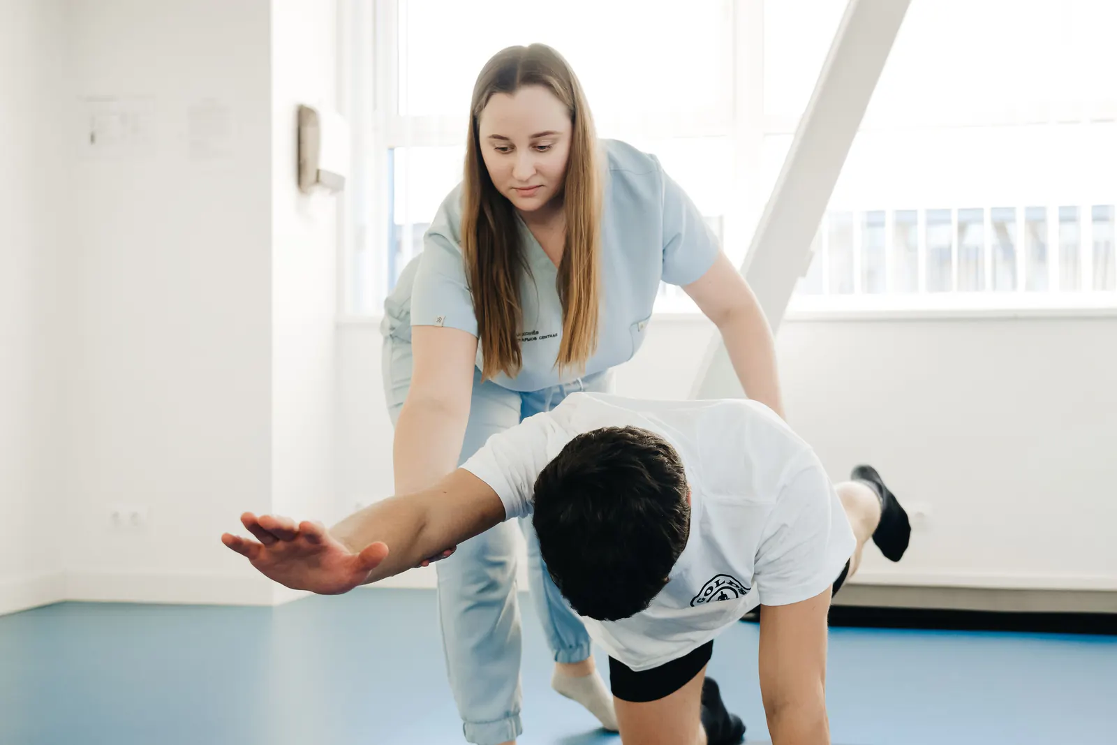 Physical therapist guiding a patient through a rehabilitation exercise
