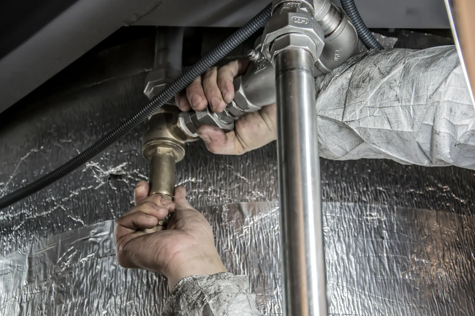 Plumber connecting pipes during an installation