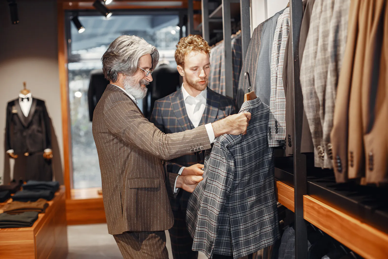 Customers reviewing suit jackets inside a specialty retail store